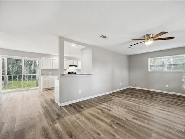 unfurnished living room with hardwood / wood-style floors and ceiling fan