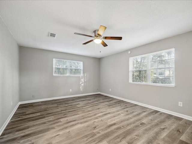 unfurnished room with hardwood / wood-style flooring and ceiling fan