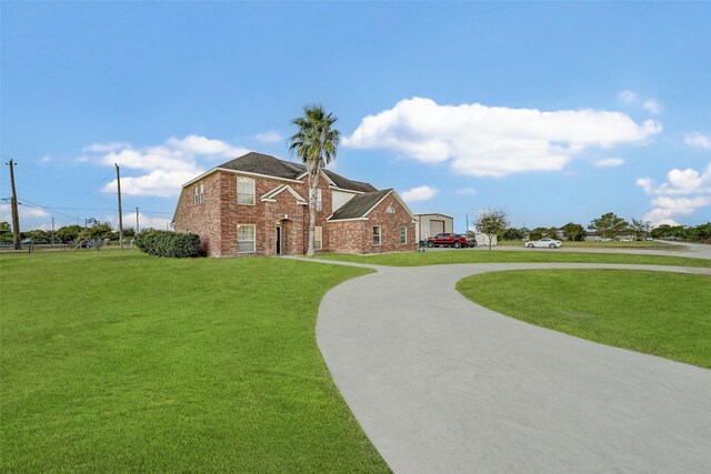 6530 Fm 3180 W, Mont Belvieu, TX 77523 - view of front facade with a front lawn, brick siding, and curved driveway