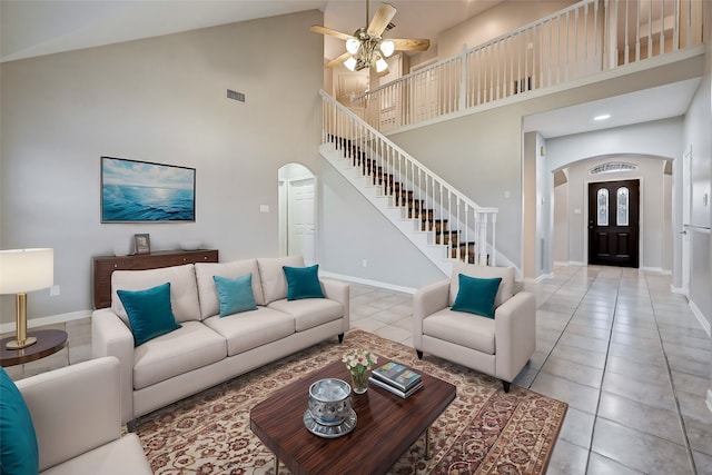 living room featuring ceiling fan, high vaulted ceiling, and light tile patterned floors