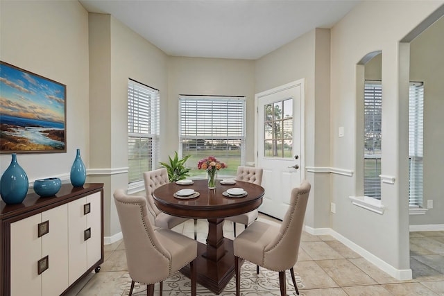 6530 Fm 3180 W, Mont Belvieu, TX 77523 - dining space with arched walkways, light tile patterned floors, and baseboards