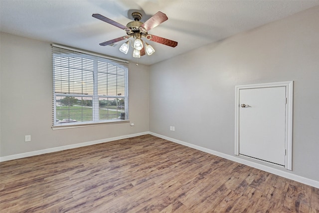 unfurnished room with a textured ceiling, hardwood / wood-style flooring, and ceiling fan