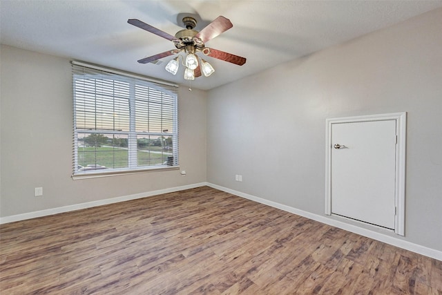 6530 Fm 3180 W, Mont Belvieu, TX 77523 - unfurnished room with wood finished floors, ceiling fan, and baseboards