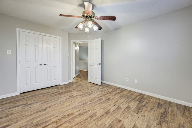 unfurnished bedroom featuring a closet, light wood-type flooring, and ceiling fan