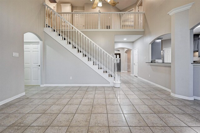 6530 Fm 3180 W, Mont Belvieu, TX 77523 - entryway with a ceiling fan, a high ceiling, arched walkways, stairs, and baseboards