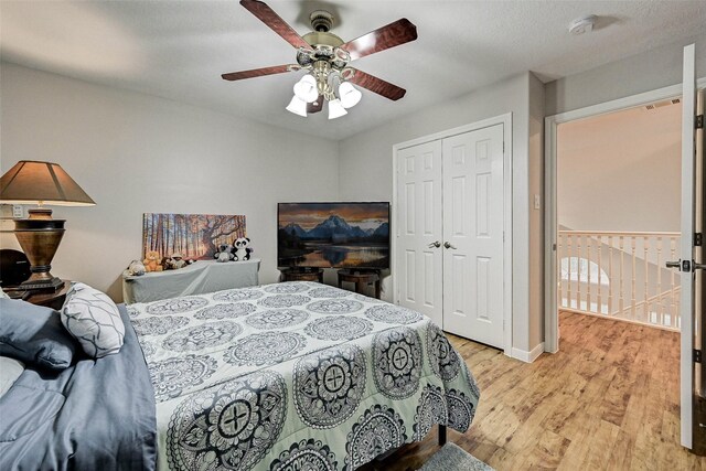 6530 Fm 3180 W, Mont Belvieu, TX 77523 - bedroom with light wood-style floors, a closet, and a ceiling fan