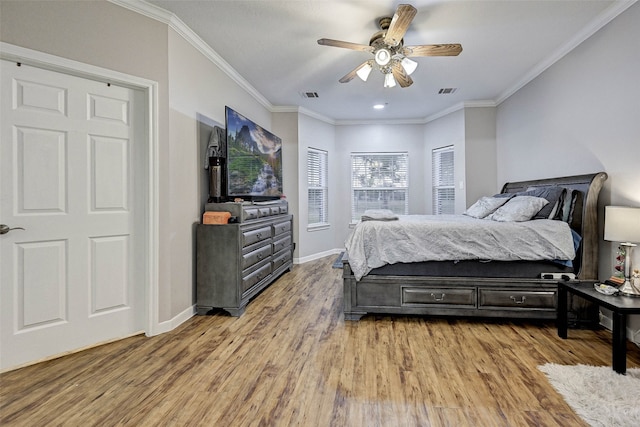 bedroom featuring ceiling fan, ornamental molding, and light hardwood / wood-style floors