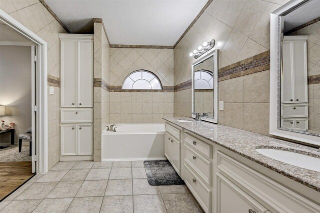 6530 Fm 3180 W, Mont Belvieu, TX 77523 - full bath with tile walls, double vanity, a bath, ornamental molding, and tile patterned floors