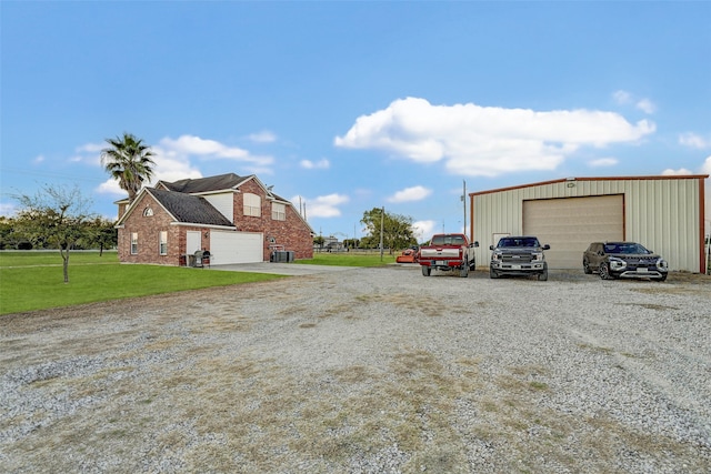 exterior space featuring a yard, an outbuilding, and a garage