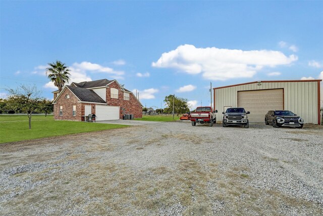 6530 Fm 3180 W, Mont Belvieu, TX 77523 - view of side of property with a garage, a lawn, and central AC