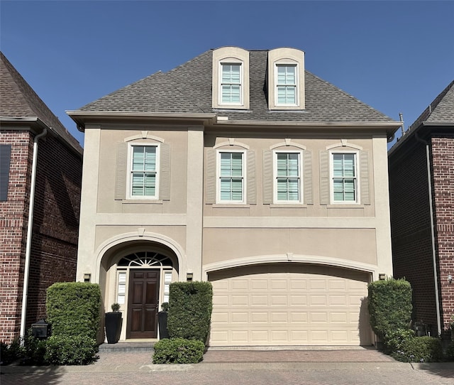 french provincial home featuring a garage