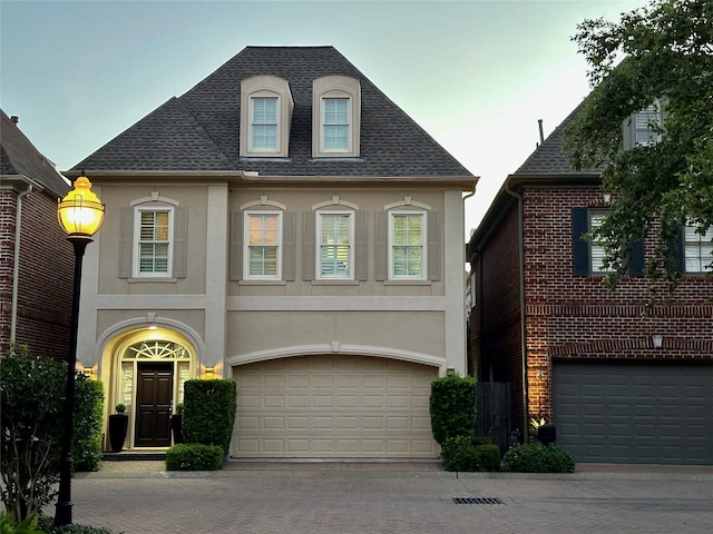 french country style house featuring a garage