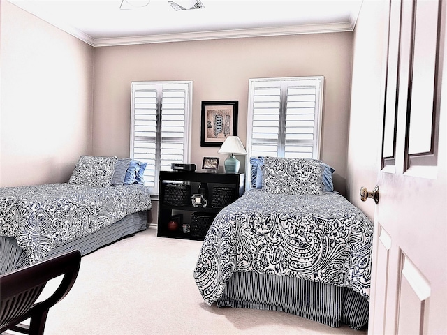 bedroom with ornamental molding and carpet flooring