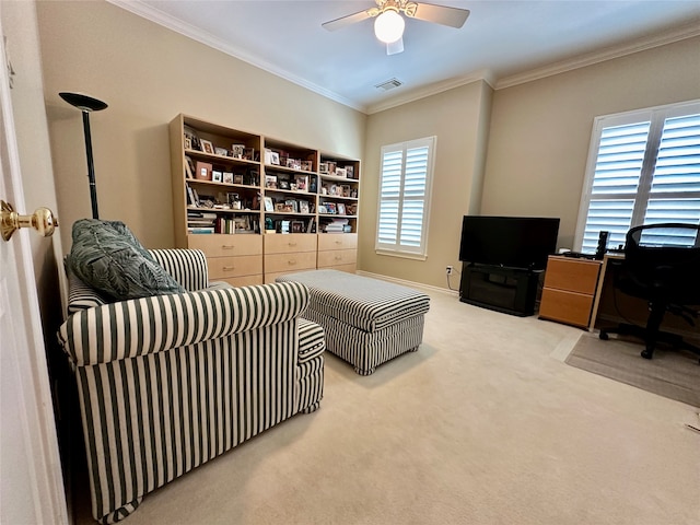 carpeted living room featuring ceiling fan, a healthy amount of sunlight, and ornamental molding