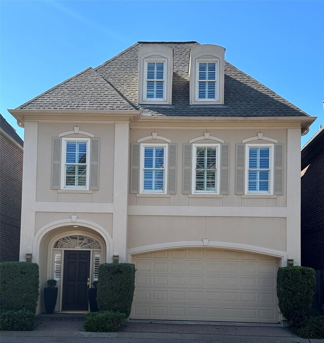 french country inspired facade featuring a garage