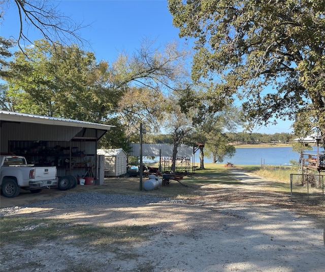 exterior space featuring a water view and a storage shed