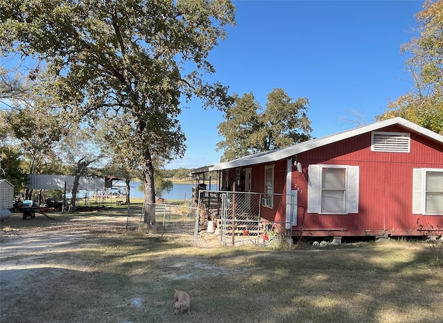 view of side of home featuring a water view