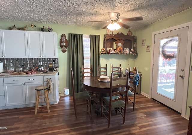 dining area featuring a textured ceiling, dark hardwood / wood-style floors, and ceiling fan