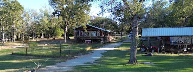 surrounding community featuring a lawn and a carport