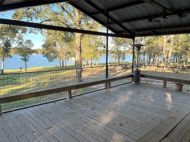 wooden terrace featuring ceiling fan and a water view