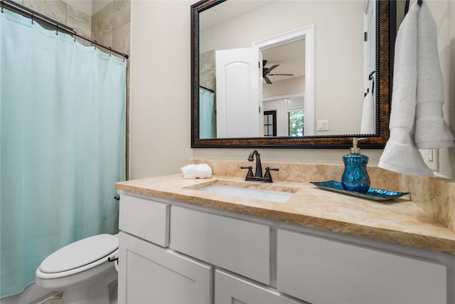 bathroom featuring vanity, toilet, curtained shower, and ceiling fan