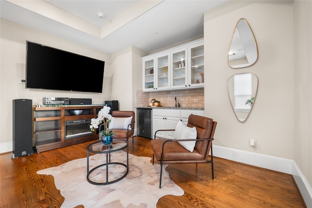 living area featuring sink and hardwood / wood-style floors