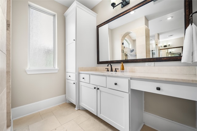 bathroom with vanity, a healthy amount of sunlight, and tile patterned flooring