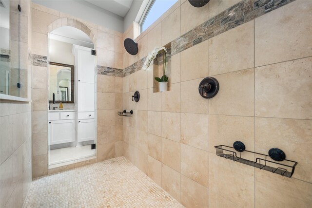 bathroom featuring vanity and a tile shower