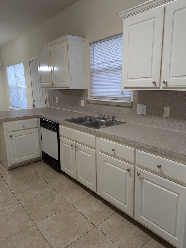 kitchen with sink, white cabinetry, dishwasher, and light tile patterned flooring