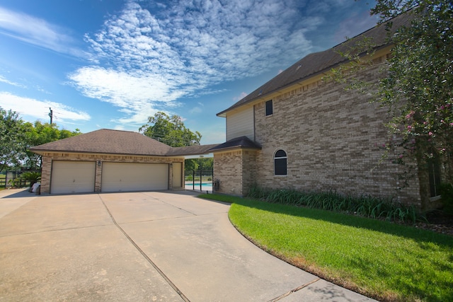 view of home's exterior with a lawn and a garage