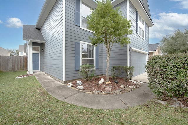 exterior space with a garage and a front lawn