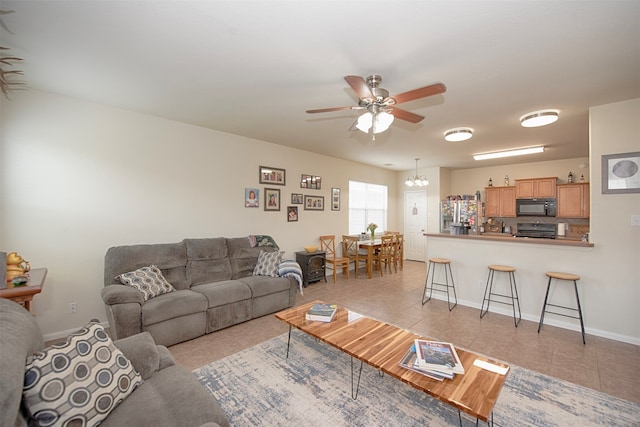 living room with ceiling fan and light tile patterned floors