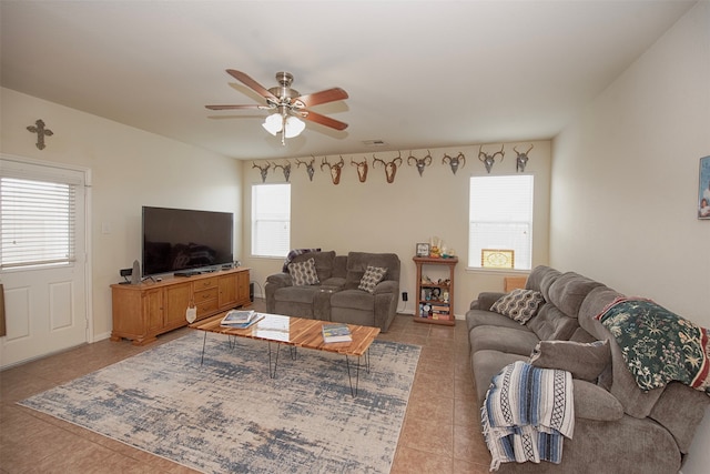 tiled living room with ceiling fan