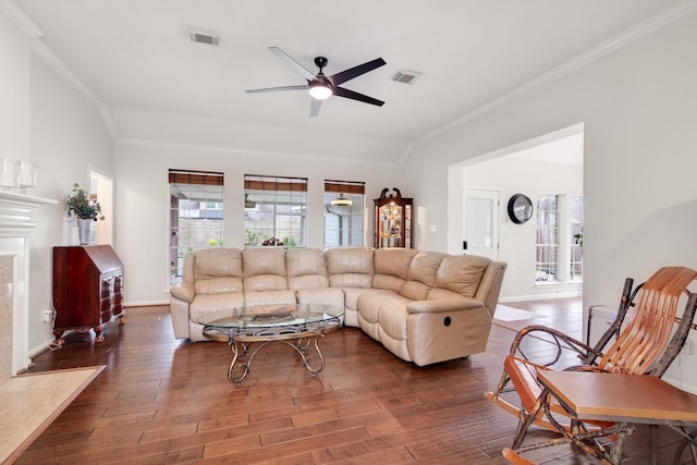 living room featuring crown molding, ceiling fan, dark hardwood / wood-style flooring, and a premium fireplace