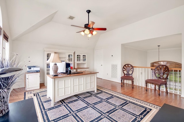 kitchen with ceiling fan, hardwood / wood-style floors, and lofted ceiling