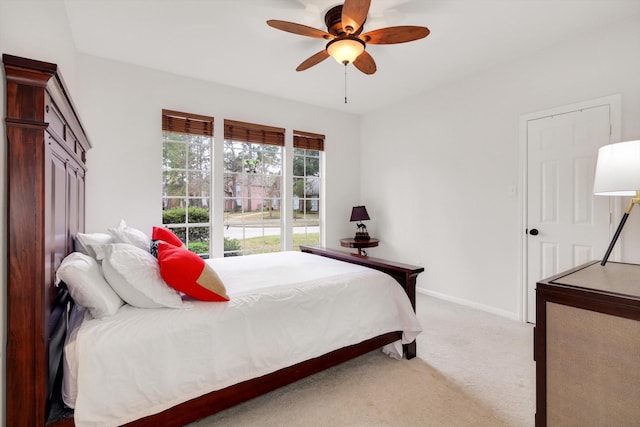 bedroom featuring ceiling fan and light carpet