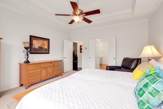 bedroom with light carpet, a tray ceiling, ceiling fan, and crown molding