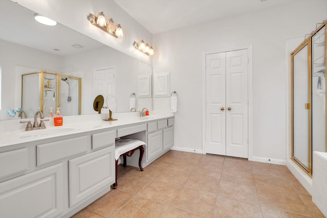 bathroom with tile patterned floors, vanity, and a shower with door