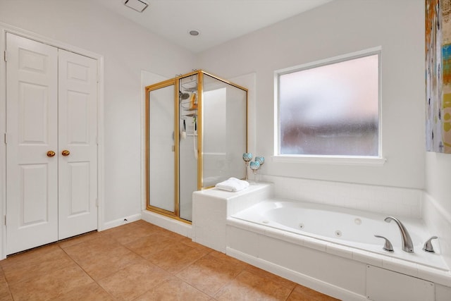 bathroom with tile patterned floors and independent shower and bath