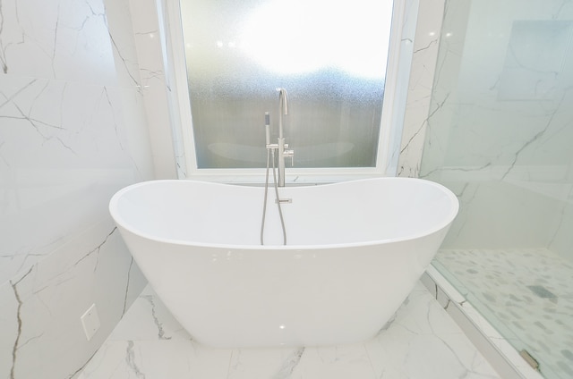 bathroom featuring a tub to relax in and a textured ceiling