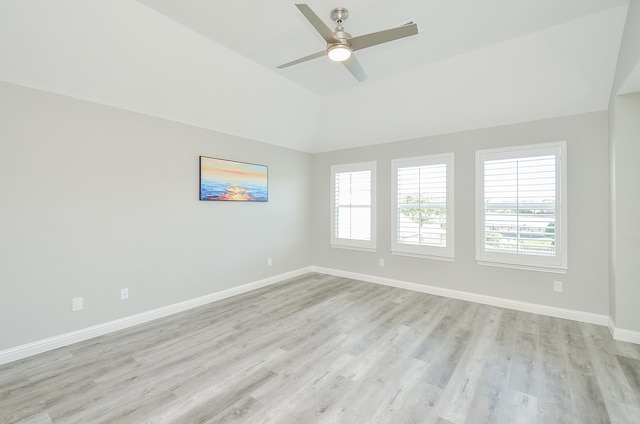 empty room featuring light wood-type flooring, ceiling fan, and vaulted ceiling