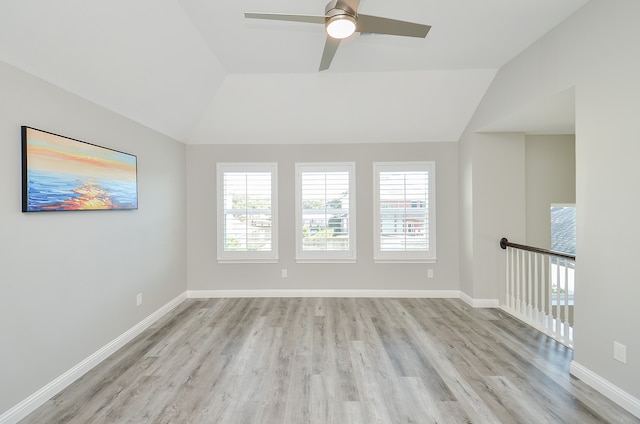 unfurnished room featuring light wood-type flooring, lofted ceiling, and ceiling fan