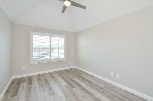 spare room featuring light hardwood / wood-style flooring, ceiling fan, and vaulted ceiling