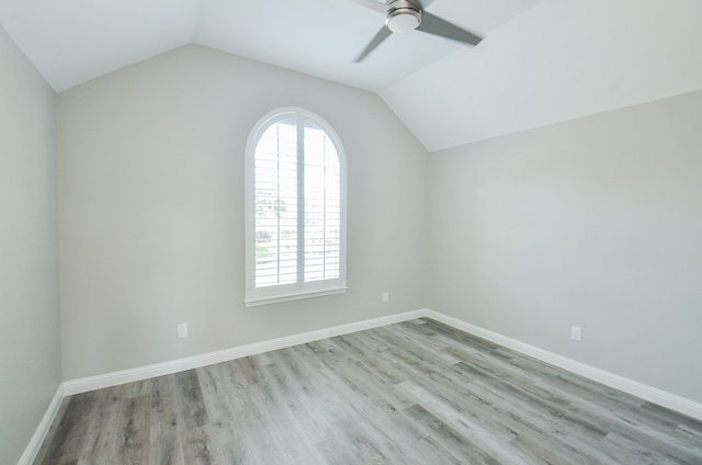 empty room featuring light wood-type flooring, lofted ceiling, and ceiling fan