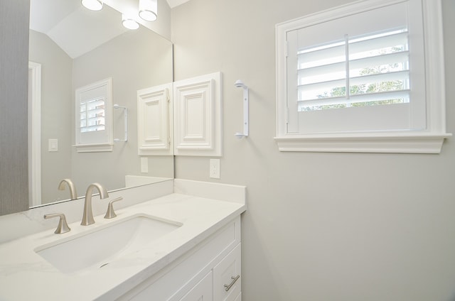 bathroom featuring vanity and vaulted ceiling