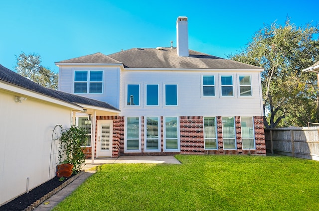 rear view of property featuring a yard