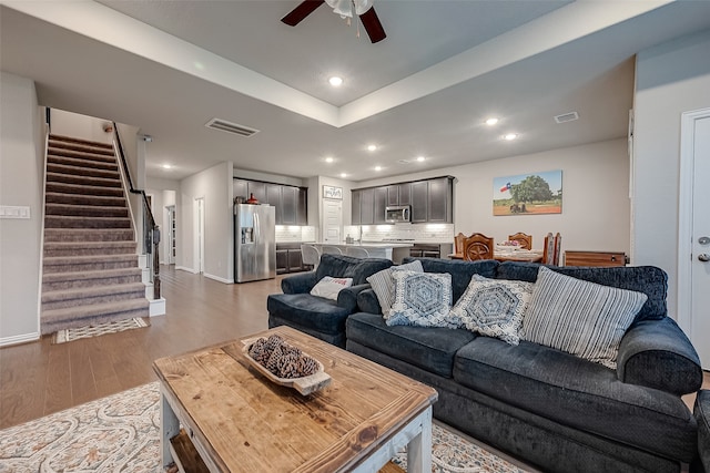 living room featuring hardwood / wood-style flooring and ceiling fan