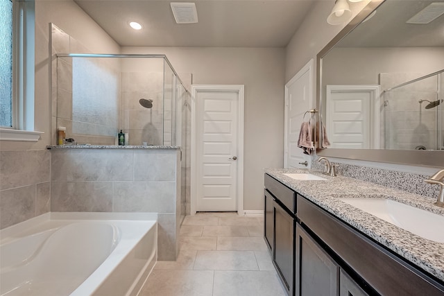 bathroom with tile patterned flooring, vanity, and independent shower and bath