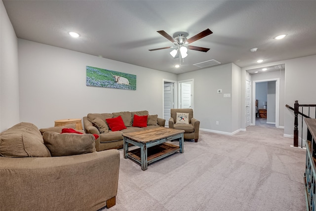 carpeted living room with ceiling fan