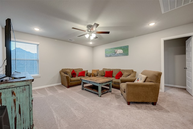 carpeted living room with ceiling fan